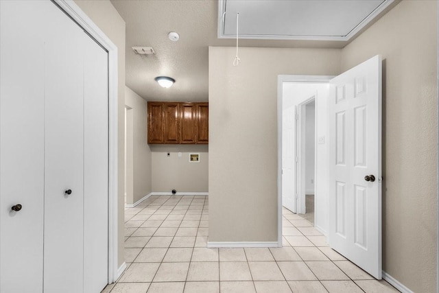 120 Southwinds Dr, Weatherford, TX 76087 - laundry area featuring light tile patterned floors, hookup for an electric dryer, attic access, washer hookup, and baseboards