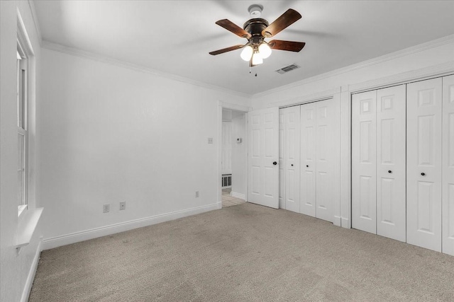 120 Southwinds Dr, Weatherford, TX 76087 - unfurnished bedroom featuring crown molding, visible vents, multiple closets, and light carpet