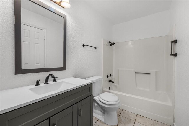 120 Southwinds Dr, Weatherford, TX 76087 - bathroom featuring vanity, shower / washtub combination, a textured wall, tile patterned floors, and toilet