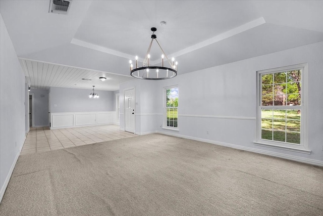 120 Southwinds Dr, Weatherford, TX 76087 - carpeted empty room with an inviting chandelier, tile patterned flooring, a wainscoted wall, visible vents, and lofted ceiling