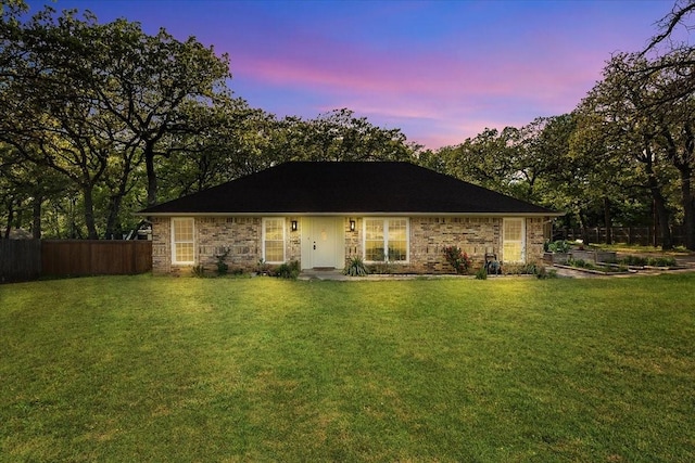 120 Southwinds Dr, Weatherford, TX 76087 - back of house at dusk featuring fence and a lawn