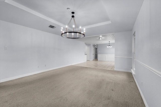 120 Southwinds Dr, Weatherford, TX 76087 - unfurnished room with a tray ceiling, light carpet, an inviting chandelier, and visible vents