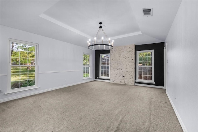 120 Southwinds Dr, Weatherford, TX 76087 - empty room with visible vents, a wealth of natural light, a tray ceiling, and an inviting chandelier