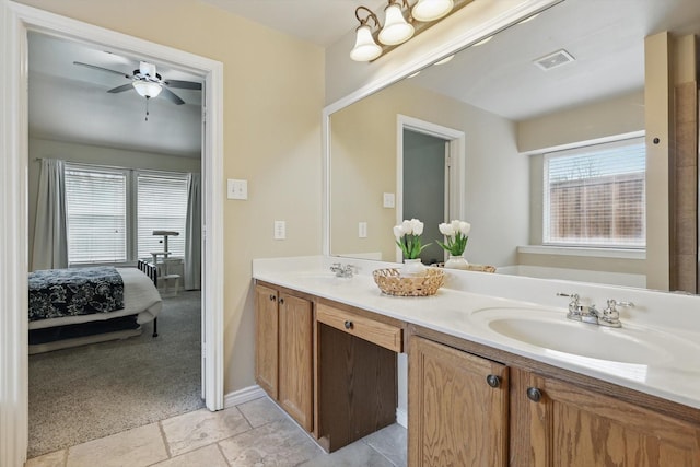 3505 Mustang Dr, Denton, TX 76210 - ensuite bathroom with double vanity, a ceiling fan, and baseboards