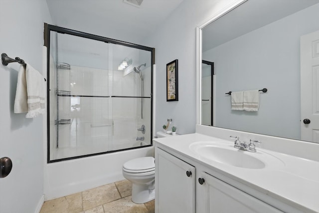3505 Mustang Dr, Denton, TX 76210 - full bathroom featuring toilet, vanity, bath / shower combo with glass door, stone tile flooring, and baseboards
