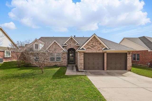 3505 Mustang Dr, Denton, TX 76210 - view of front facade featuring an attached garage, concrete driveway, a front yard, and brick siding