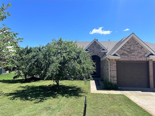 3505 Mustang Dr, Denton, TX 76210 - view of front of home with brick siding, an attached garage, and a front lawn