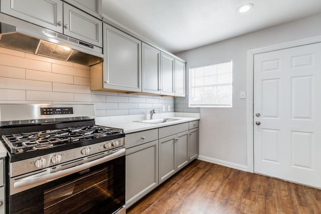 1312 Greenwood Dr, Garland, TX 75041 - kitchen featuring a sink, gray cabinetry, stainless steel range with gas stovetop, under cabinet range hood, and decorative backsplash