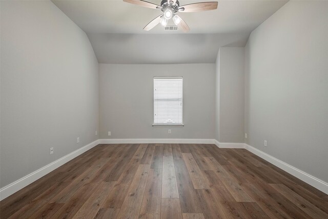 10 Monticello Ct, Mansfield, TX 76063 - empty room with ceiling fan, vaulted ceiling, dark wood-type flooring, and baseboards