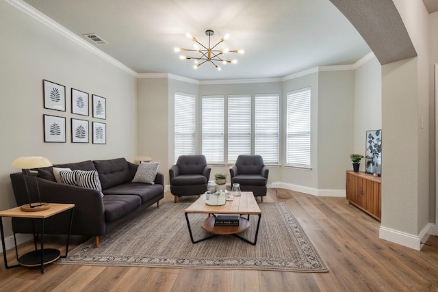 10 Monticello Ct, Mansfield, TX 76063 - living area featuring baseboards, wood finished floors, a chandelier, crown molding, and arched walkways
