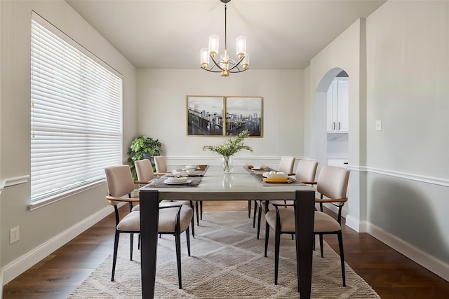 10 Monticello Ct, Mansfield, TX 76063 - dining area with arched walkways, a chandelier, baseboards, and dark wood-style floors