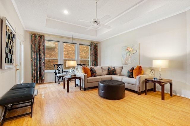 241 Tanbark Cir, Coppell, TX 75019 - living area featuring a raised ceiling, light wood-type flooring, ceiling fan, crown molding, and recessed lighting