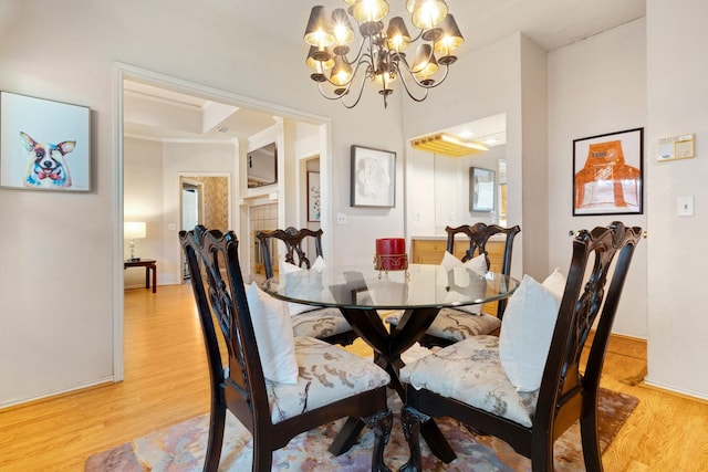 241 Tanbark Cir, Coppell, TX 75019 - dining room with a chandelier, light wood finished floors, and baseboards