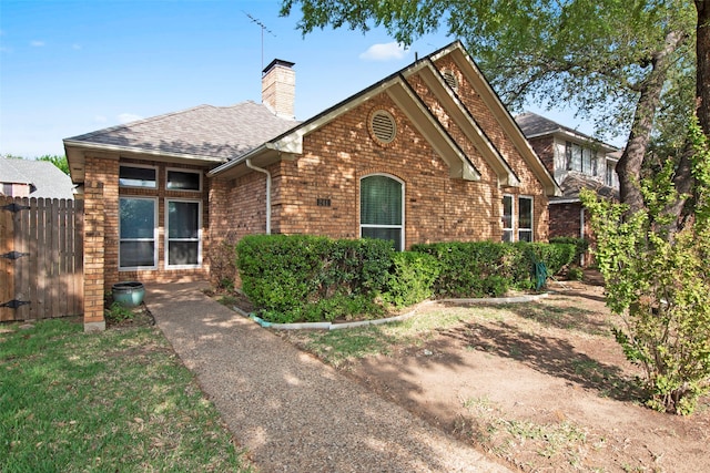241 Tanbark Cir, Coppell, TX 75019 - view of front of home featuring brick siding, a chimney, and roof with shingles
