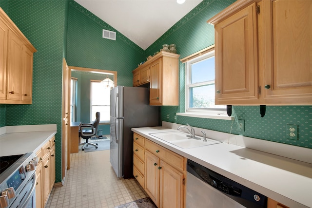241 Tanbark Cir, Coppell, TX 75019 - kitchen featuring stainless steel appliances, a sink, vaulted ceiling, light brown cabinets, and light countertops