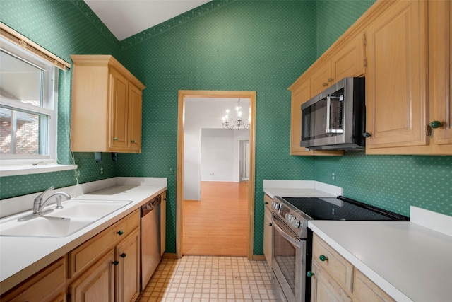 241 Tanbark Cir, Coppell, TX 75019 - kitchen featuring stainless steel appliances, a sink, light countertops, a chandelier, and light brown cabinetry