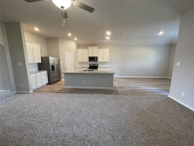 2100 Yarbrough, Anna, TX 75409 - kitchen featuring a sink, open floor plan, stainless steel appliances, white cabinets, and ceiling fan