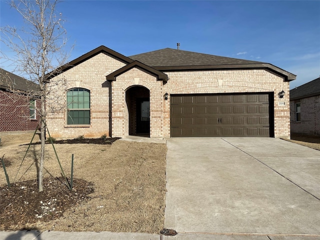 2100 Yarbrough, Anna, TX 75409 - french country style house featuring driveway, brick siding, a garage, and roof with shingles