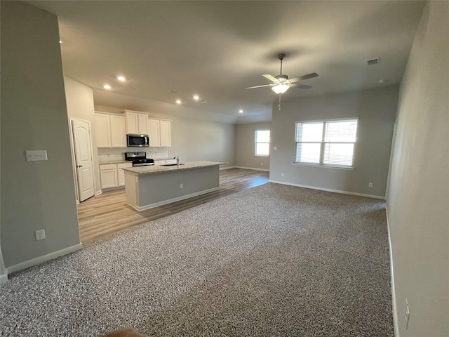 2100 Yarbrough, Anna, TX 75409 - kitchen with white cabinets, ceiling fan, appliances with stainless steel finishes, open floor plan, and light colored carpet