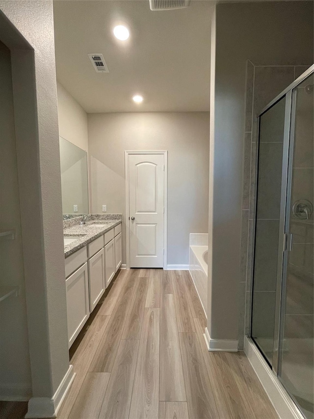 2100 Yarbrough, Anna, TX 75409 - full bathroom featuring a stall shower, double vanity, wood finished floors, and a bath