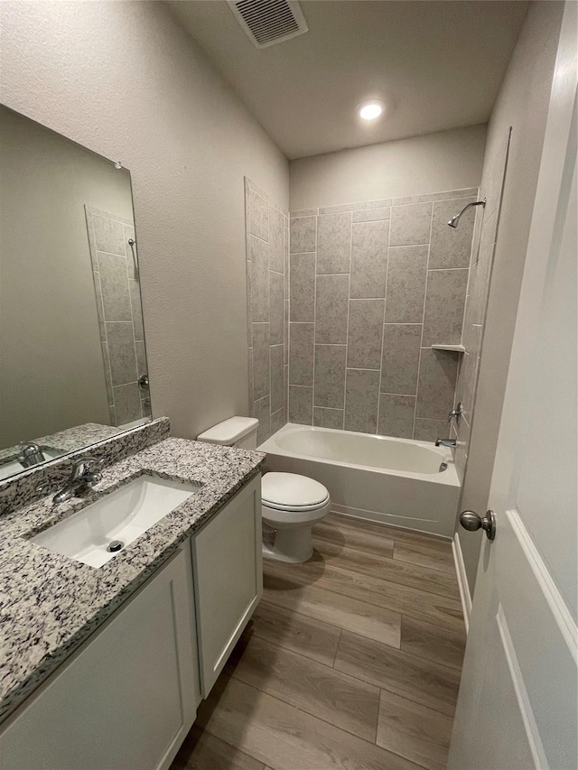 2100 Yarbrough, Anna, TX 75409 - bathroom featuring toilet, vanity, wood finished floors, tub / shower combination, and visible vents