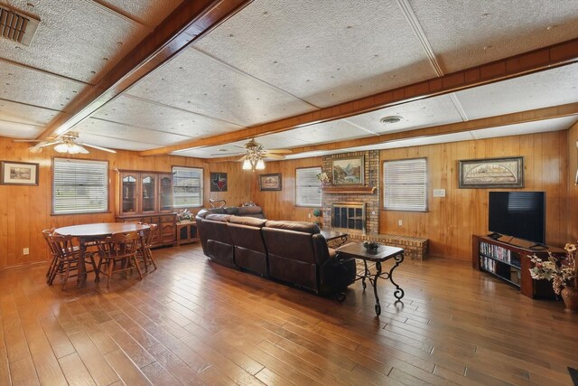 1509 Tinker Rd, Colleyville, TX 76034 - living area featuring a fireplace, ceiling fan, visible vents, and wood-type flooring