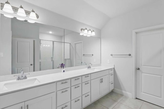 bathroom featuring tile patterned floors, a stall shower, double vanity, baseboards, and lofted ceiling