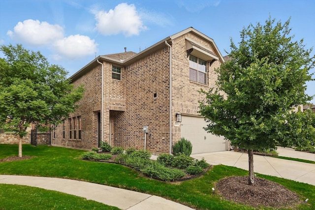 view of side of property featuring brick siding, concrete driveway, an attached garage, and a yard