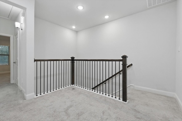 corridor with carpet, attic access, an upstairs landing, baseboards, and recessed lighting