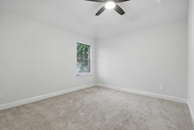unfurnished room with carpet floors, baseboards, and a ceiling fan
