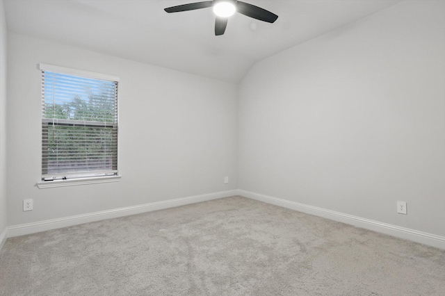 unfurnished room with ceiling fan, vaulted ceiling, carpet flooring, and baseboards