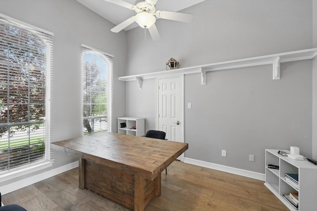 office with baseboards, a ceiling fan, and wood finished floors