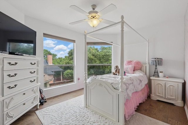 bedroom with a ceiling fan and wood finished floors
