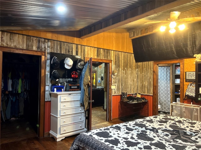 109 Bluebonnet Dr, Whitney, TX 76692 - bedroom featuring wood walls, dark wood-type flooring, and beam ceiling