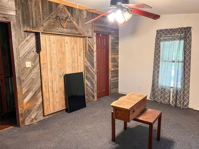 109 Bluebonnet Dr, Whitney, TX 76692 - living area with wooden walls, carpet, and a ceiling fan