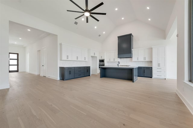 814 Montrose Dr, Rockwall, TX 75087 - kitchen featuring ceiling fan, open floor plan, white cabinetry, high vaulted ceiling, and backsplash