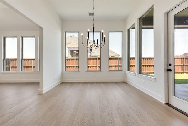 814 Montrose Dr, Rockwall, TX 75087 - unfurnished dining area featuring light wood-style floors, a chandelier, plenty of natural light, and baseboards