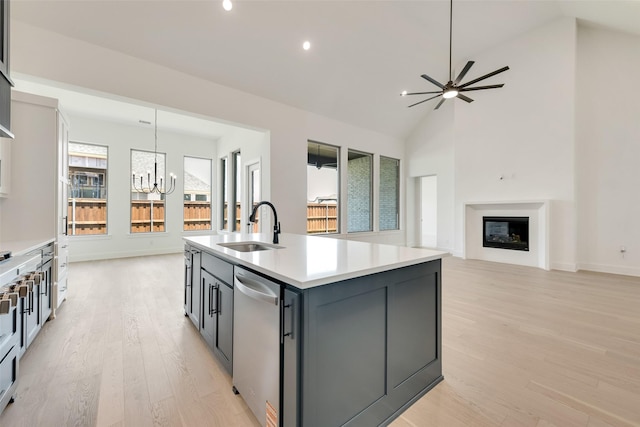 814 Montrose Dr, Rockwall, TX 75087 - kitchen with a sink, stainless steel dishwasher, a chandelier, light wood-style floors, and light countertops