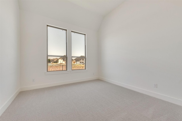 814 Montrose Dr, Rockwall, TX 75087 - spare room with light colored carpet, baseboards, and vaulted ceiling