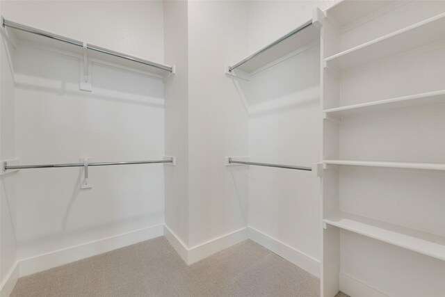 814 Montrose Dr, Rockwall, TX 75087 - walk in closet featuring light colored carpet