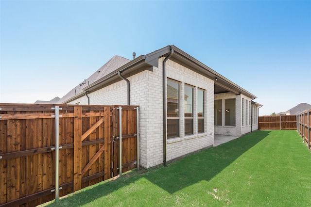 814 Montrose Dr, Rockwall, TX 75087 - view of side of home with brick siding and a gate