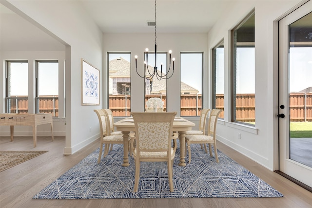 814 Montrose Dr, Rockwall, TX 75087 - dining area featuring a chandelier, wood finished floors, and baseboards