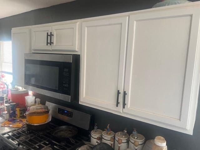 3614 Lovingood Dr, Dallas, TX 75241 - kitchen with stainless steel appliances and white cabinetry