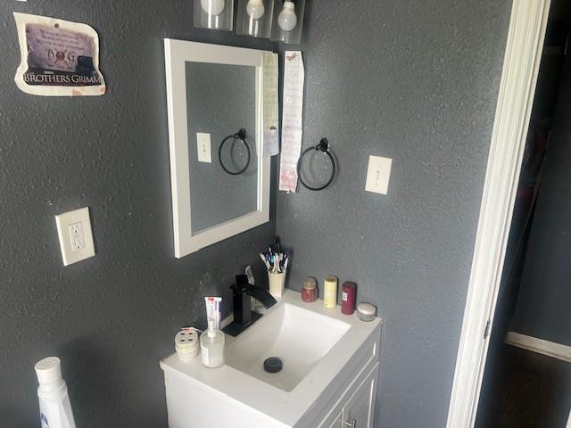 3614 Lovingood Dr, Dallas, TX 75241 - bathroom featuring a textured wall and vanity