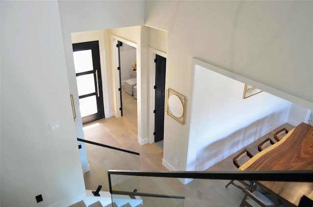 stairway featuring baseboards and wood finished floors