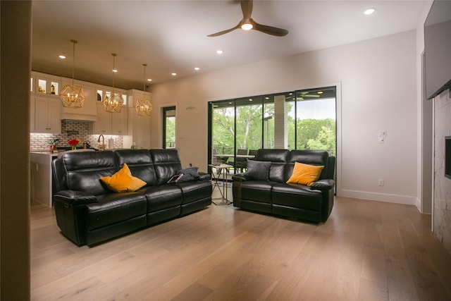 2519 Tamaron Cv, Cedar Hill, TX 75104 - living area featuring light wood finished floors, ceiling fan, recessed lighting, a chandelier, and baseboards