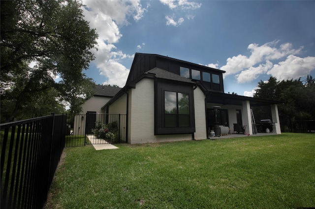 2519 Tamaron Cv, Cedar Hill, TX 75104 - back of house featuring brick siding, a patio area, and a gate