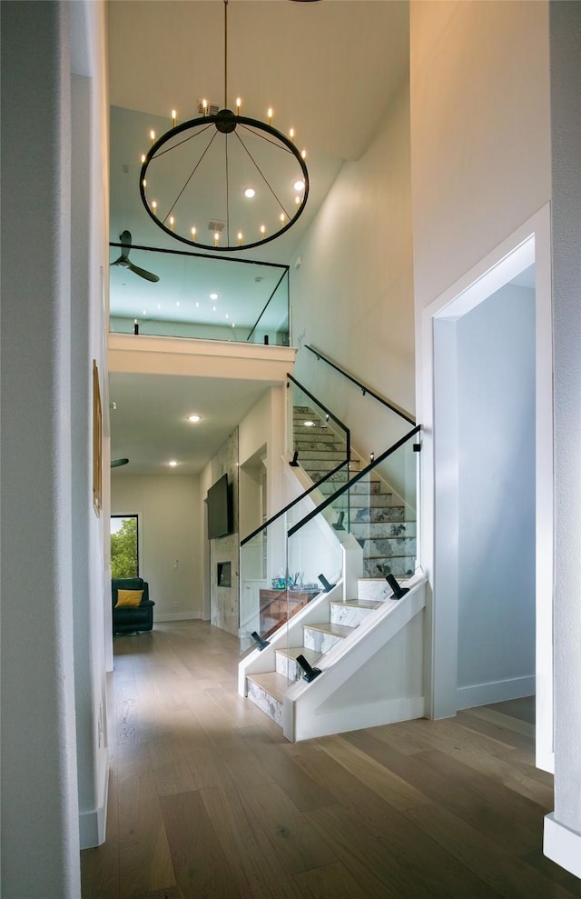 2519 Tamaron Cv, Cedar Hill, TX 75104 - stairway with wood finished floors, a chandelier, a towering ceiling, and baseboards