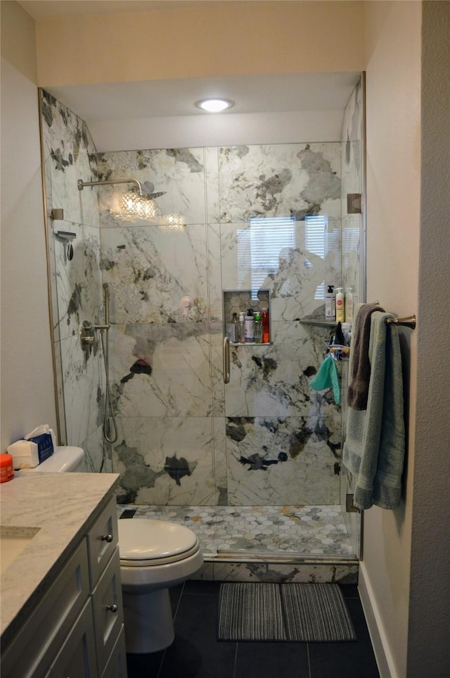 bathroom with a marble finish shower, toilet, tile patterned floors, and vanity