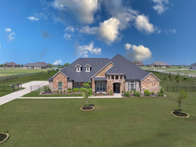 view of front of home featuring stone siding, a front lawn, and fence